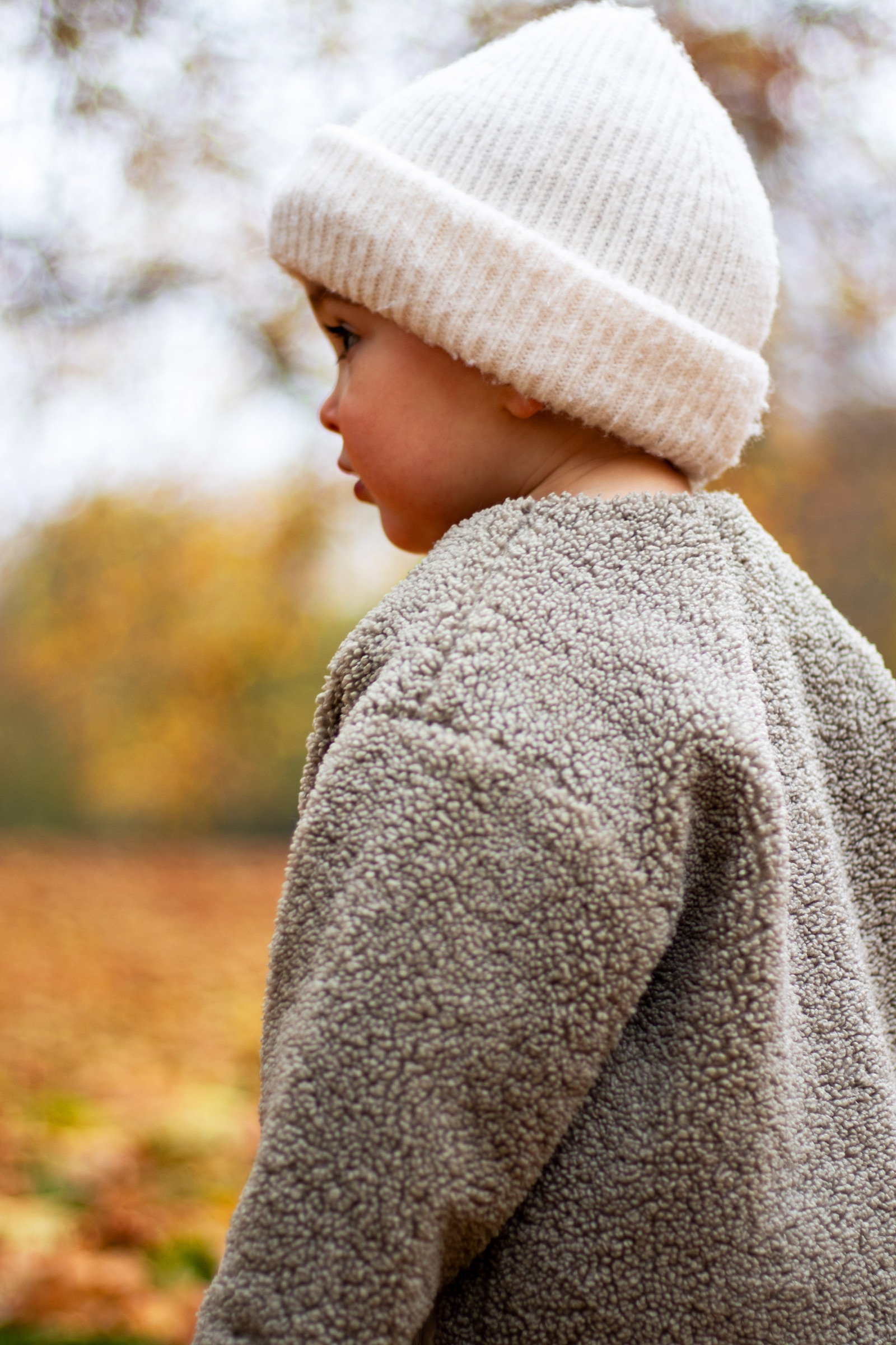 Baby in the park during autumn — family moment